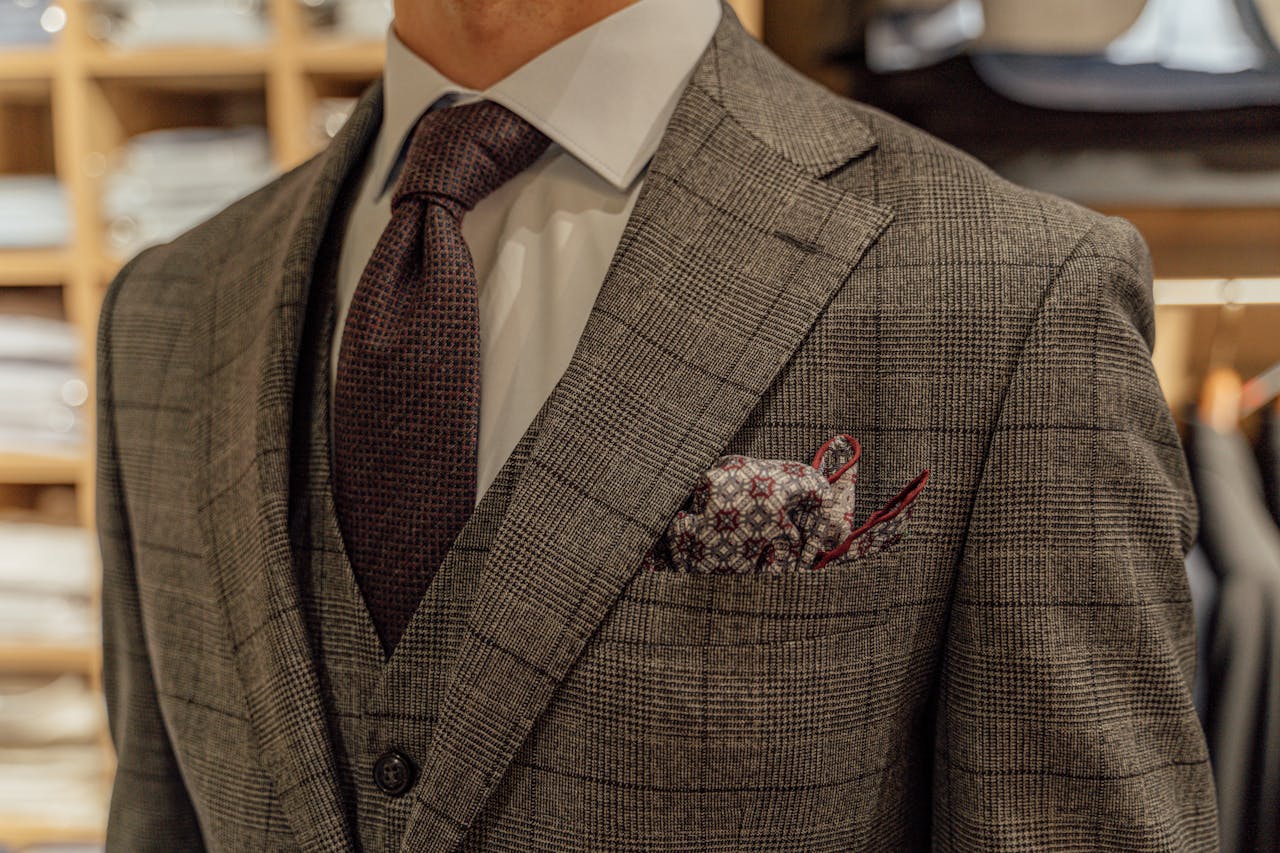 Close-up of a tailored suit showcased in a fashion boutique, highlighting intricate patterns and style.